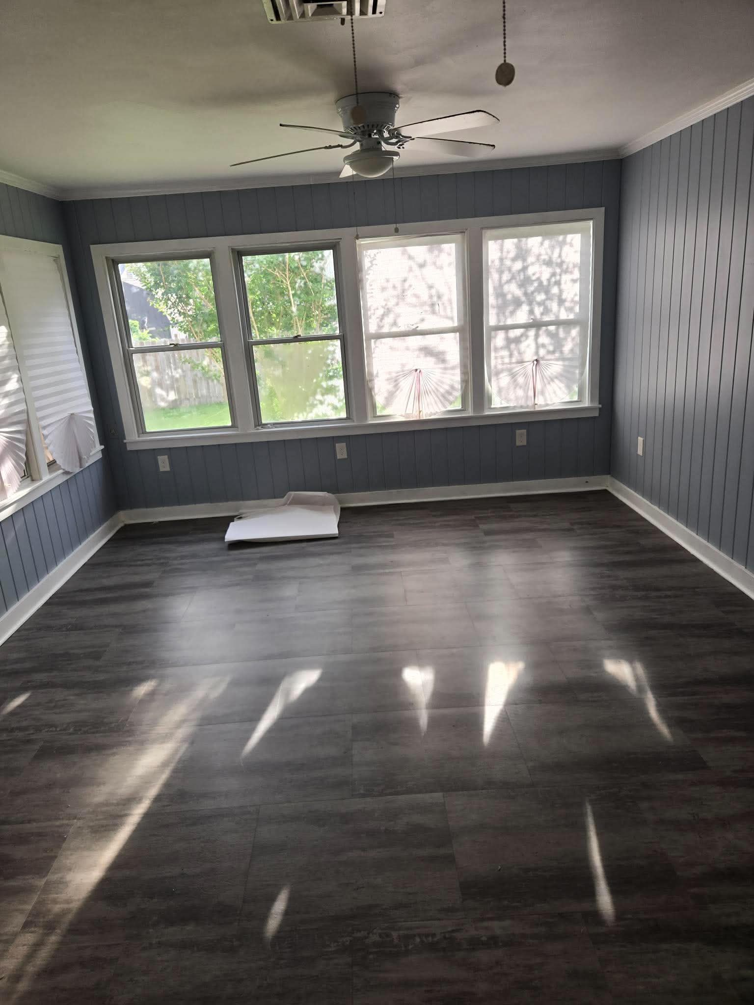 Finished room with dark flooring and large window